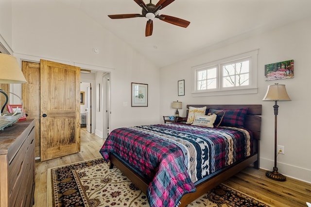 bedroom featuring light wood-type flooring, high vaulted ceiling, ceiling fan, and baseboards