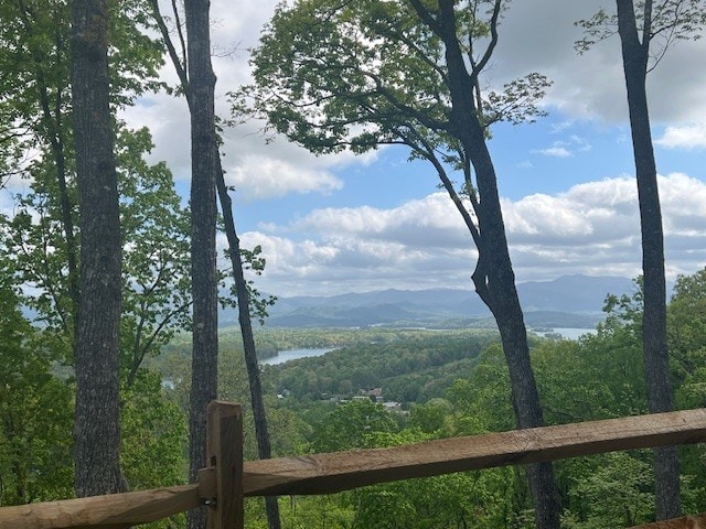 view of mountain feature featuring a water view and a wooded view