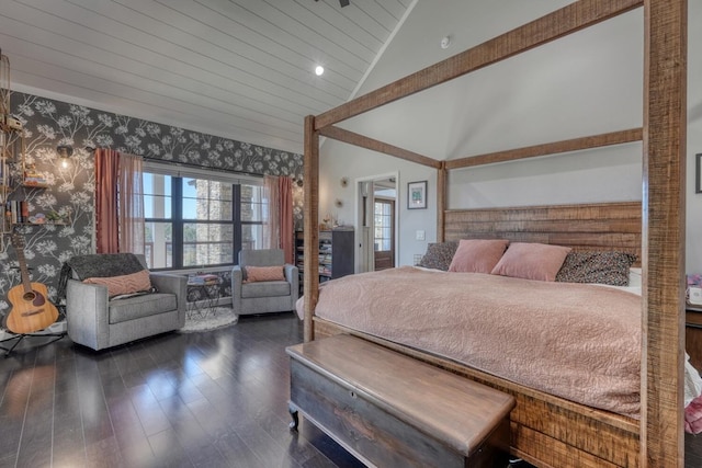 bedroom with vaulted ceiling, dark wood finished floors, and wallpapered walls