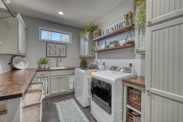 laundry area with cabinet space, dark wood finished floors, washing machine and dryer, a sink, and recessed lighting