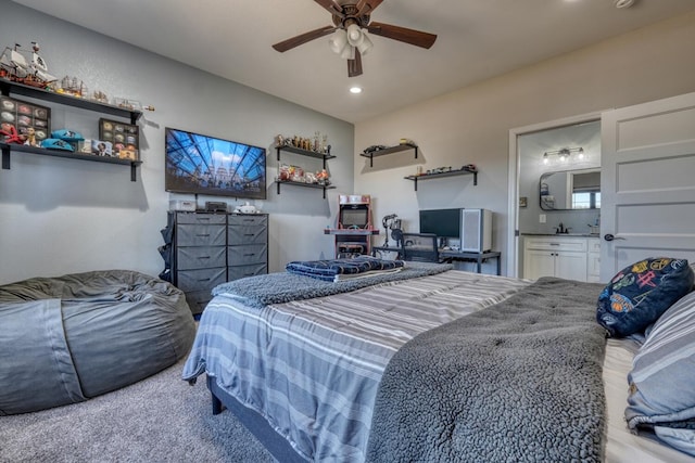 bedroom featuring ceiling fan, recessed lighting, light colored carpet, a sink, and ensuite bath