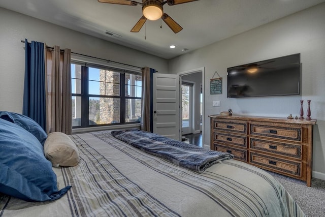 carpeted bedroom with ceiling fan, visible vents, and baseboards