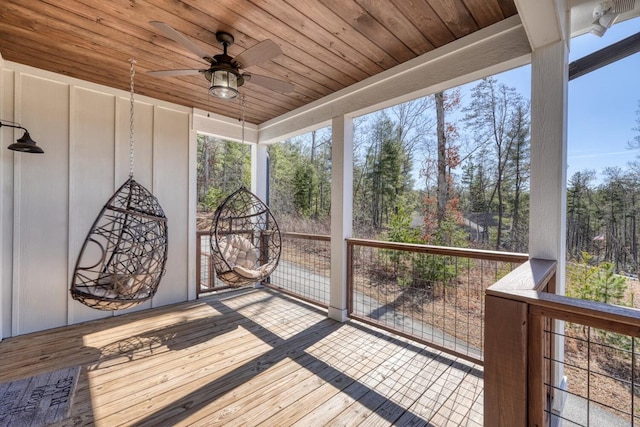 sunroom with wood ceiling, a ceiling fan, and a wealth of natural light