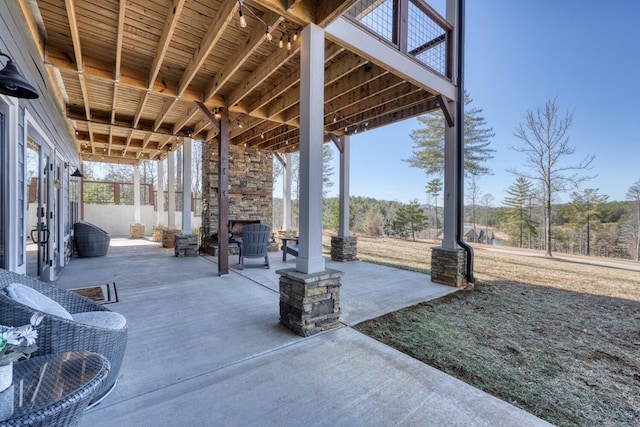 view of patio / terrace with an outdoor stone fireplace