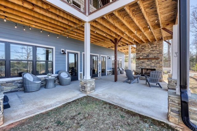 view of patio with an outdoor stone fireplace