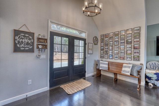 entryway with french doors, an inviting chandelier, dark wood-type flooring, high vaulted ceiling, and baseboards