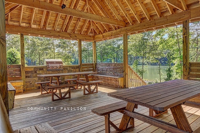 sunroom / solarium with lofted ceiling and a water view