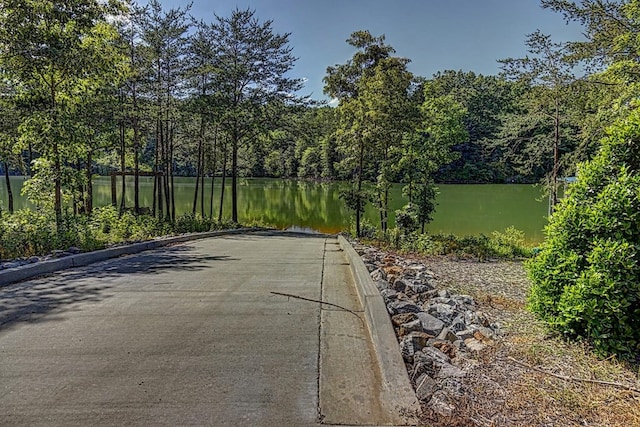 view of street featuring curbs and a water view