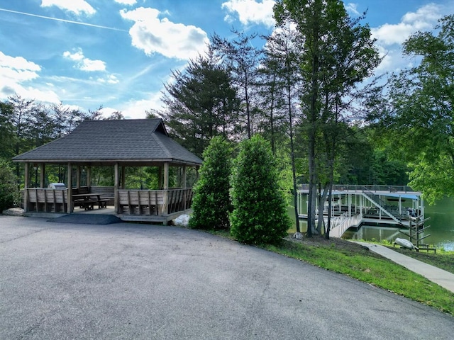 surrounding community with a water view and a gazebo