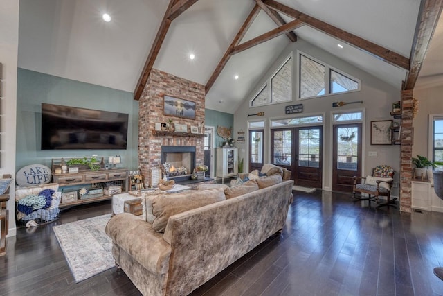 living room with dark wood-style floors, high vaulted ceiling, and french doors