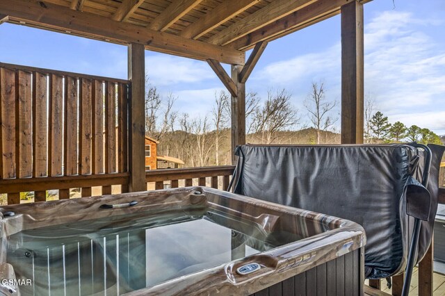 wooden terrace featuring a hot tub