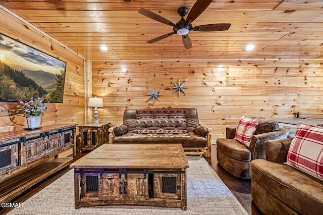 interior space with ceiling fan, wooden ceiling, and wooden walls