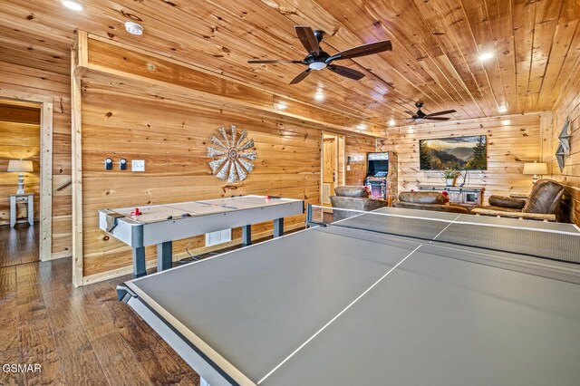 rec room featuring ceiling fan, wood ceiling, and dark hardwood / wood-style floors