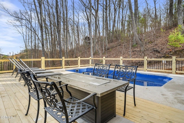 view of swimming pool with a wooden deck