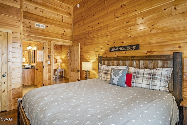 bedroom featuring wooden walls