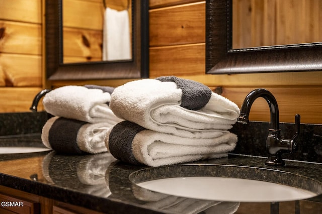 details featuring wooden walls and sink