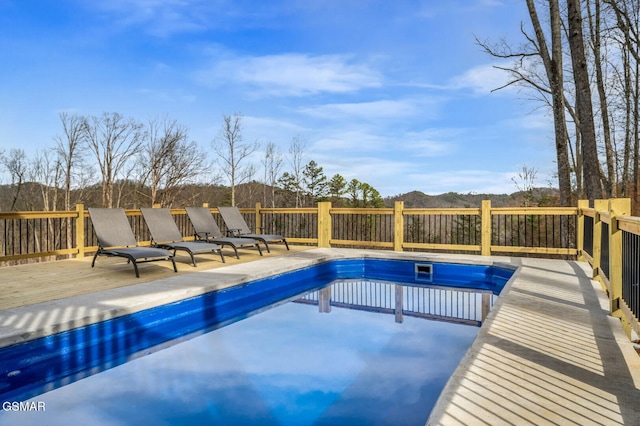 view of pool with a deck with mountain view