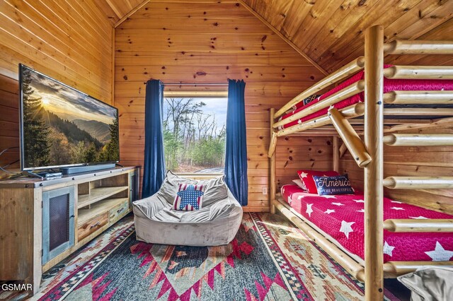 bedroom with wood walls, wooden ceiling, and vaulted ceiling