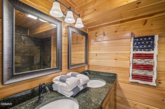 bathroom with wooden walls, vanity, and wood ceiling