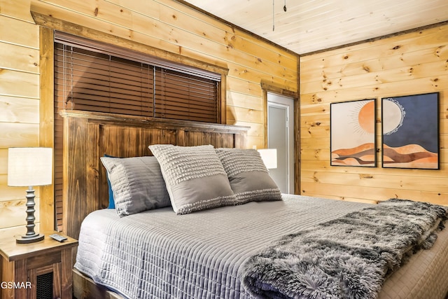 bedroom with wooden ceiling and wood walls