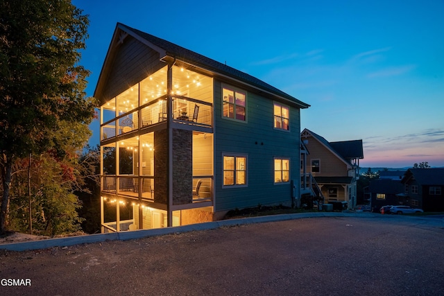 property exterior at dusk with a balcony