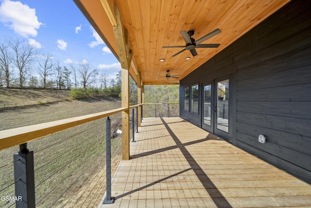 wooden deck featuring a ceiling fan and french doors