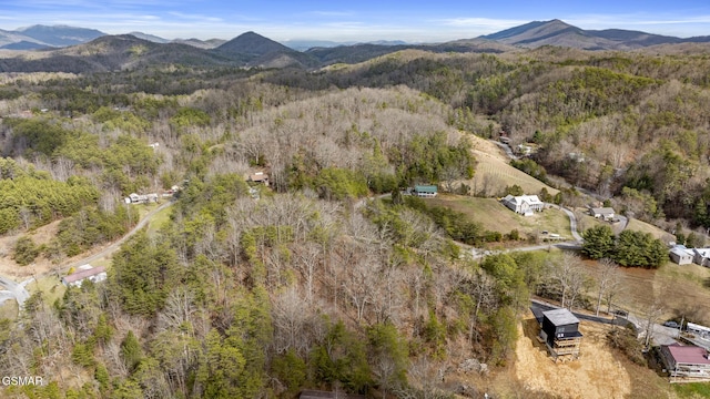 bird's eye view featuring a mountain view and a wooded view