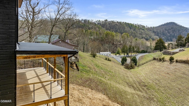 view of yard with a mountain view and a wooded view