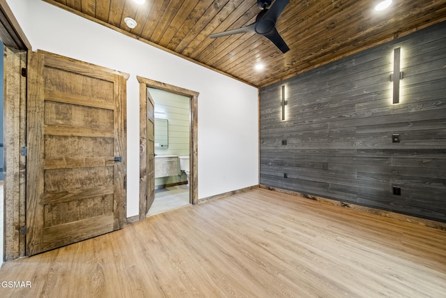 unfurnished room featuring a ceiling fan, wood finished floors, baseboards, wood ceiling, and wood walls