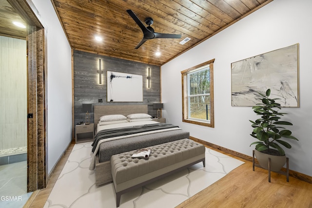 bedroom featuring visible vents, baseboards, wood ceiling, lofted ceiling, and wood finished floors