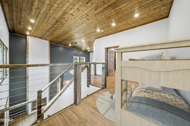 interior space with wood finished floors, wood ceiling, recessed lighting, and an upstairs landing