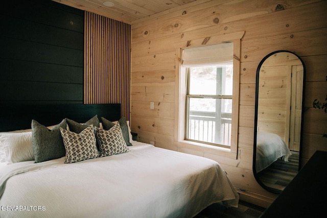 bedroom with wooden ceiling and wood walls