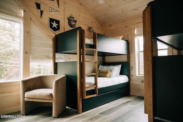 unfurnished bedroom with lofted ceiling, wood-type flooring, wooden ceiling, and wood walls