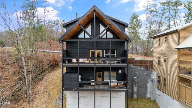 back of house featuring a balcony