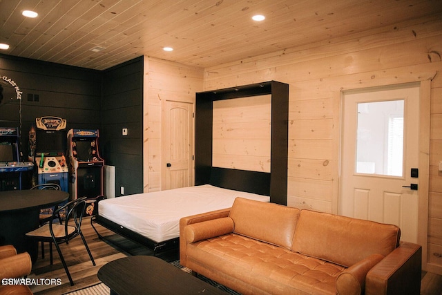 bedroom with wood ceiling, wood-type flooring, and wooden walls