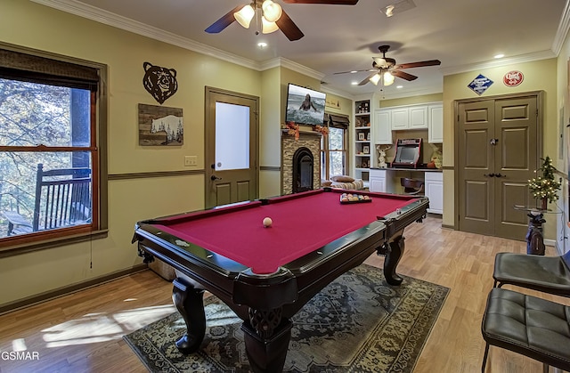 2846 Mountain View Cir, Sevierville, TN 37862 - playroom with ceiling fan, a stone fireplace, light wood-style flooring, billiards table, and ornamental molding