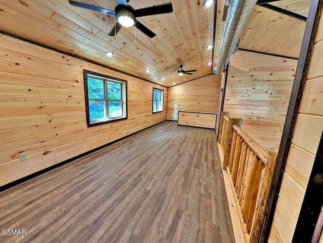 additional living space with dark wood-type flooring, wooden walls, vaulted ceiling, ceiling fan, and wood ceiling