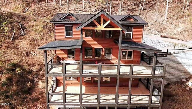 back of house featuring a wooden deck