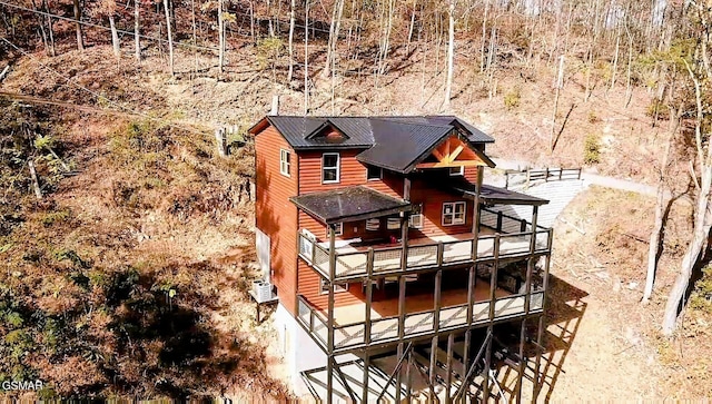 back of property with a balcony and a deck