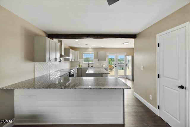 kitchen with beamed ceiling, gray cabinets, kitchen peninsula, and appliances with stainless steel finishes