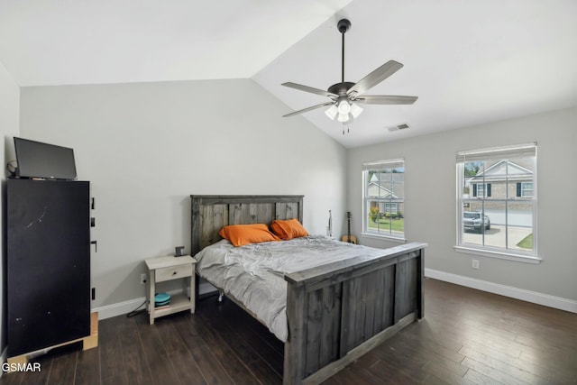 bedroom featuring ceiling fan, dark hardwood / wood-style flooring, and vaulted ceiling