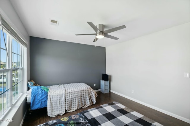 bedroom featuring ceiling fan and dark wood-type flooring