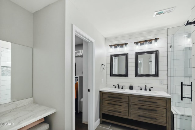 bathroom featuring tile patterned floors, vanity, and an enclosed shower