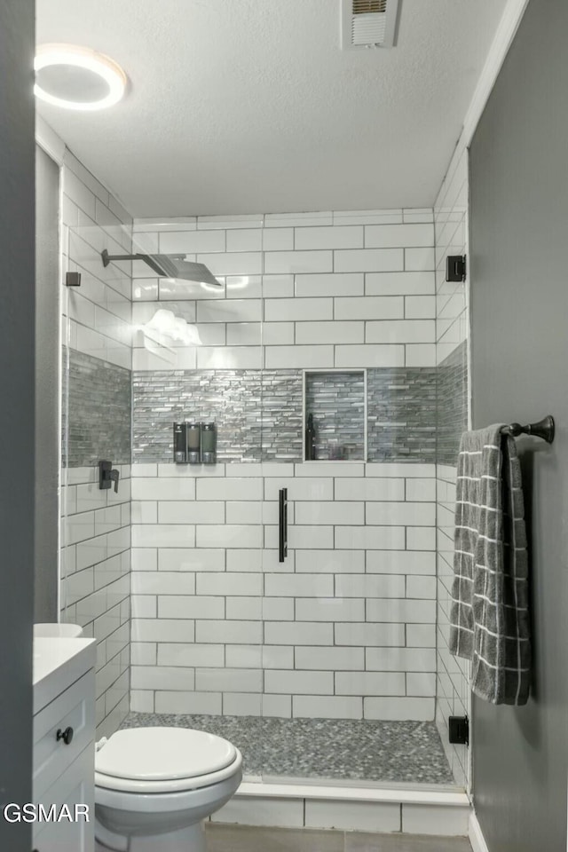 bathroom featuring vanity, toilet, and a shower with door