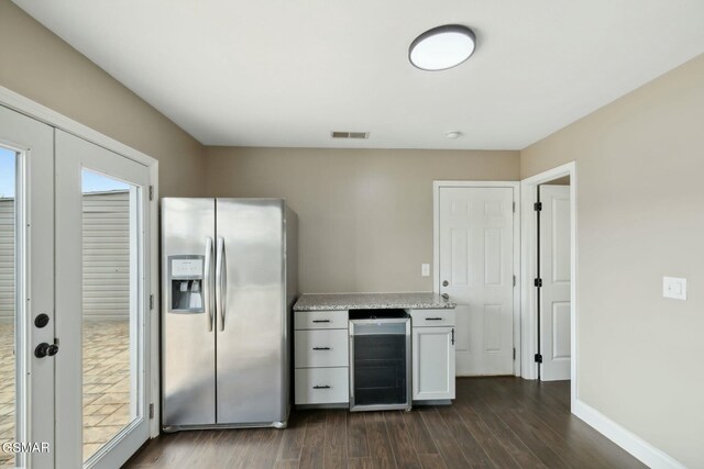 kitchen with french doors, stainless steel refrigerator with ice dispenser, dark hardwood / wood-style flooring, beverage cooler, and white cabinetry