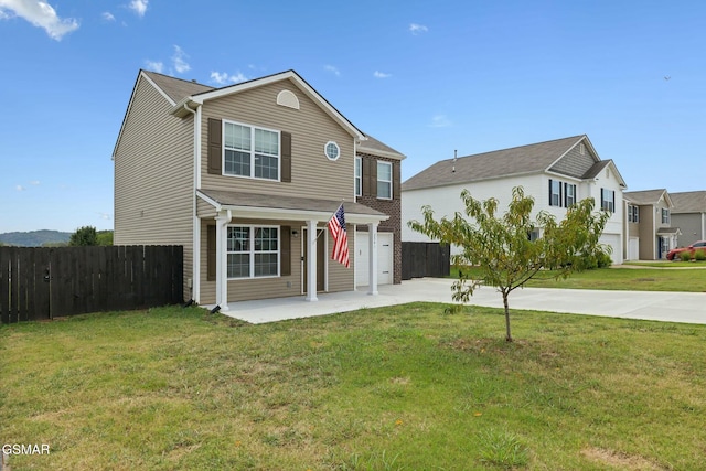 view of front of property featuring a front lawn and a garage