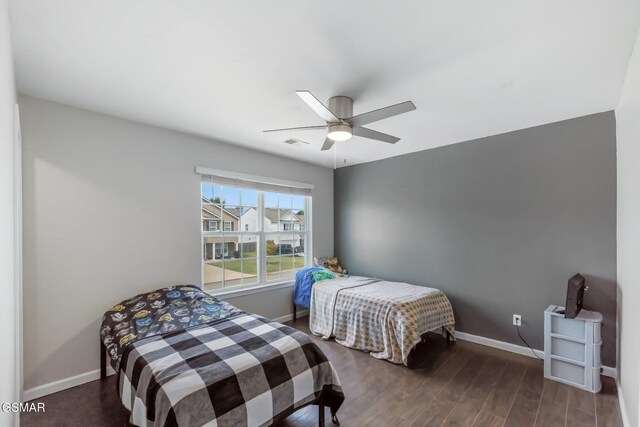 bedroom with ceiling fan and dark wood-type flooring