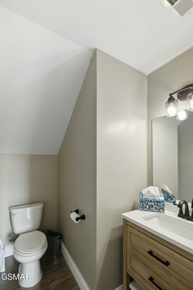 bathroom with vanity, hardwood / wood-style flooring, and toilet