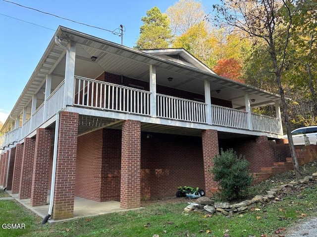 rear view of house featuring brick siding