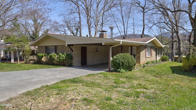 ranch-style home with driveway, a front yard, brick siding, a carport, and a chimney
